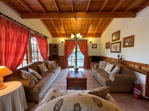 a large living room with couches and a table at Kapilio Cottage House 