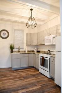 a kitchen with white cabinets and a white stove top oven at Perfect Pittsburgh Home Close To City & Airport in Pittsburgh