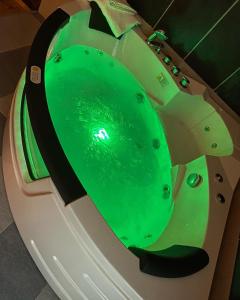 a bath tub with a green water in it at Apartman17 in Belgrade