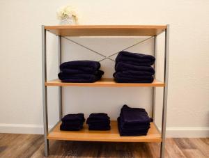 a shelf with four black towels on it at Perfect Pittsburgh Home Close To City & Airport in Pittsburgh