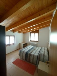 a bedroom with a bed in a room with wooden ceilings at Residence Cime d'Oro in Andalo