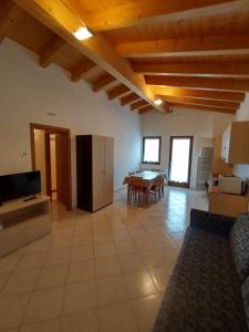 a large living room with a kitchen and a table at Residence Cime d'Oro in Andalo