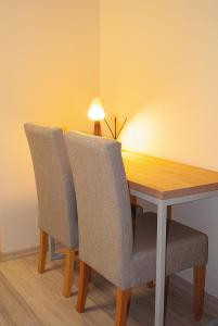 a dining room table with two chairs and a lamp at Redwood Hostel in Lublin