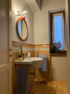 ein Bad mit einem Waschbecken und einem Spiegel in der Unterkunft Casale Riorso in Orvieto