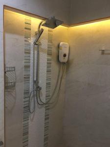 a shower in a bathroom with a shower head at Snapper House in Khao Lak