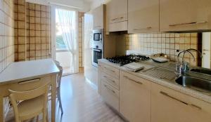 a kitchen with a sink and a stove at Spacious apartment at Como lake in Mandello del Lario