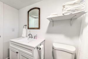 a white bathroom with a sink and a mirror at Bright 2-Story Condo 8 Mi to Grindstone Lake in Ruidoso Downs +16 photos