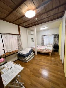 a room with two beds and a table at Villa Ukishima - Vacation STAY 07308v in Naha