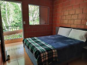 a bedroom with a bed in a brick wall at Recanto do Zezé in Gonçalves