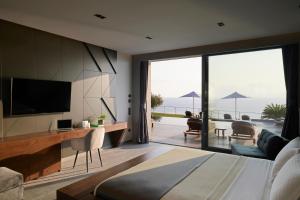 a bedroom with a view of the ocean at Villa OMNIA - Luxury Bound on Earth in Nea Moudania