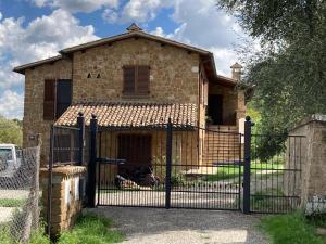 a stone house with a gate in front of it at Casale Riorso in Orvieto