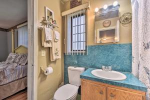 a bathroom with a toilet and a sink and a bed at Cozy Jacksonville Home with Yard about 8 Mi to Dtwn in Jacksonville +18 photos