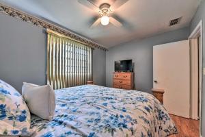 a bedroom with a bed and a ceiling fan at Cozy Jacksonville Home with Yard about 8 Mi to Dtwn in Jacksonville