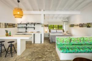 a kitchen and living room with a bed and a couch at El Encuentro Surf Lodge in Cabarete