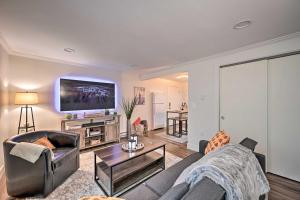 ein Wohnzimmer mit einem Sofa und einem TV an der Wand in der Unterkunft Cozy Seattle Apt in Ballard about 7 Mi to Dtwn! in Seattle
