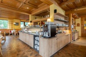 a large kitchen with wooden walls and wooden ceilings at Hotel Gasthof Krahlehenhof in Filzmoos