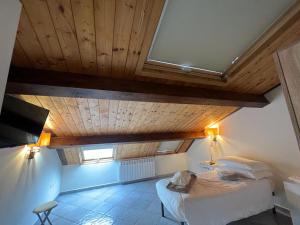 a bedroom with a bed and a wooden ceiling at IL PALAZZO - Luxury Home & Event in Cosenza