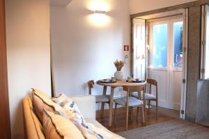 a living room with a couch and a table at Living Aliados Mezzanine Flat W/ AC in Porto
