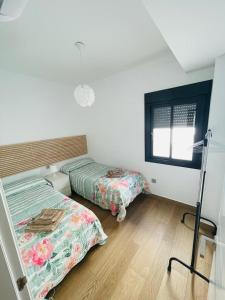 Posteľ alebo postele v izbe v ubytovaní Tríplex Cruz del Mar Beach, Apartamentos Living Sur