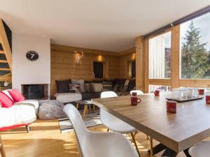 a living room with a table and chairs and a couch at Appartement Les Arcs 1800, 4 pièces, 8 personnes - FR-1-346-321 in Arc 1800