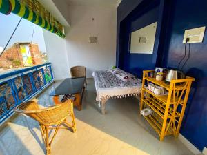 a room with a bed and a table on a balcony at Comfort and Cozy in Orchha