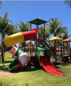 a playground with a slide in a park at Ap Aquaville resort -CE in Aquiraz