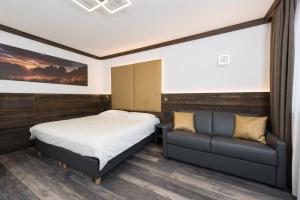 Voodi või voodid majutusasutuse Hotel Chalet Sas Morin toas
