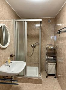 a bathroom with a shower and a white sink at AJO Vienna Ambassador Family House with Free Parking in Vienna