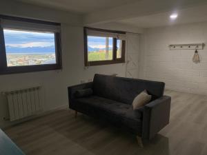 a living room with a couch and two windows at Mirando al canal in Ushuaia