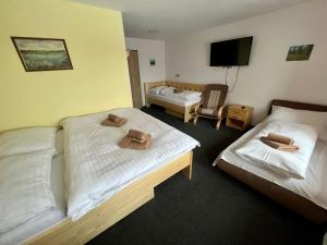 Posteľ alebo postele v izbe v ubytovaní Horský hotel Paprsek