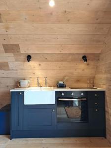 a kitchen with a sink and an oven at The Pigsty in Crieff