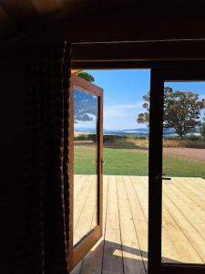 an open door with a view of a wooden deck at The Pigsty in Crieff