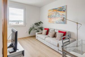a living room with a couch and a tv at Tejo River View Apartment nearby Belém in Lisbon