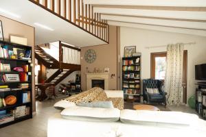 a living room with a white couch and a staircase at Casa Furia in Ponte della Venturina