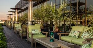 a row of chairs and a table on a patio at Hotel Montevideo - Leading Hotels of the World in Montevideo