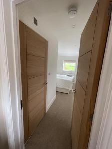 a hallway with a door to a room with a bed at Newly renovated 3 Bed property - countryside views in Dunstall