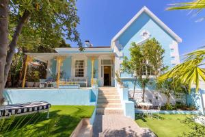 a villa with a swimming pool and a house at Amina Boutique Hotel in Cape Town