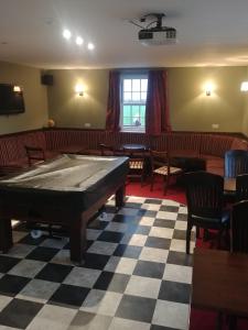 a room with a pool table in a restaurant at Unicorn in Selby