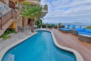 a swimming pool on the deck of a house at Modern 3-bedroom villa with pool in Tortola Island