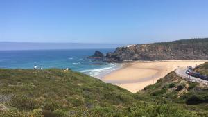a view of a beach with the ocean at Sudoeste Guest House in Odeceixe