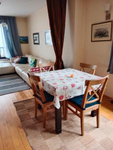 a dining room table and chairs in a living room at Mountain Escape Bansko 1BR apartment in Bansko