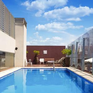 uma grande piscina azul ao lado de um edifício em Recoleta Grand em Buenos Aires