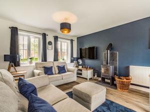 a living room with a couch and a fireplace at Lantern House in Filey