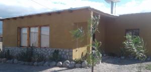 a small house with a building at Los Chañares in San Carlos