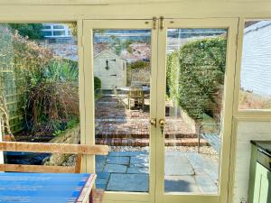 a sliding glass door with a view of a patio at Camel Cottage in Padstow