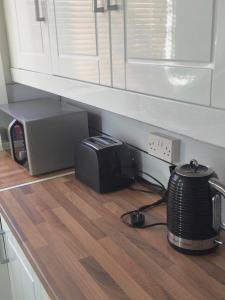 a kitchen counter with a microwave and a toaster at Vinery House in Leeds