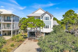 an aerial view of a large white house at Casablanca - Beach home with heated pool, bikes and more, sleeps 13! in St. George Island