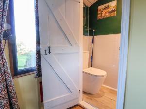 a bathroom with a toilet and a door at The Suffolk in St Asaph