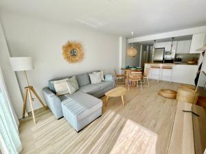 a living room with a blue couch and a kitchen at Marina Real 82 by homeprive in Denia