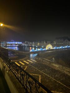 a view of a river at night from a bridge at Appartement cosy face à la Mayenne in Laval